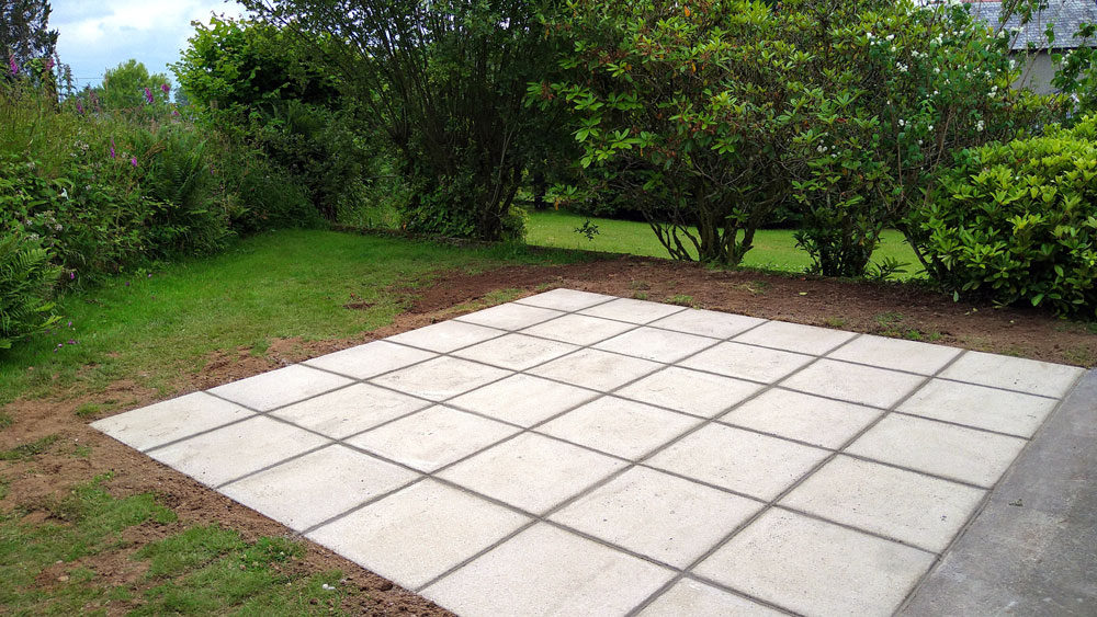 Simple patio slab installation in garden